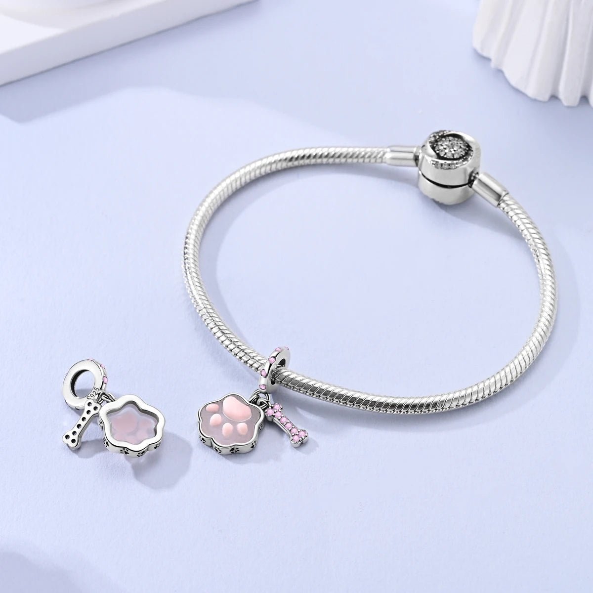 Liora Atelier Glow in the Dark Luminous Pink Paw & Bone Dangle Charm