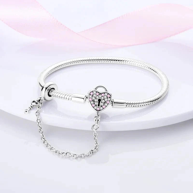 Liora Atelier Heart Lock Charm Bracelet with Pink Accents and Safety Chain